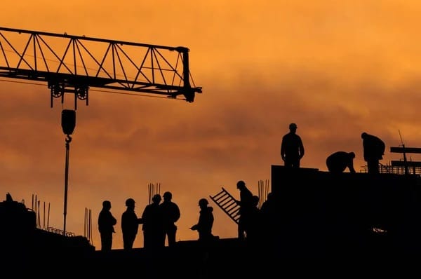 Construction site with cranes and workers — insured risks covered
